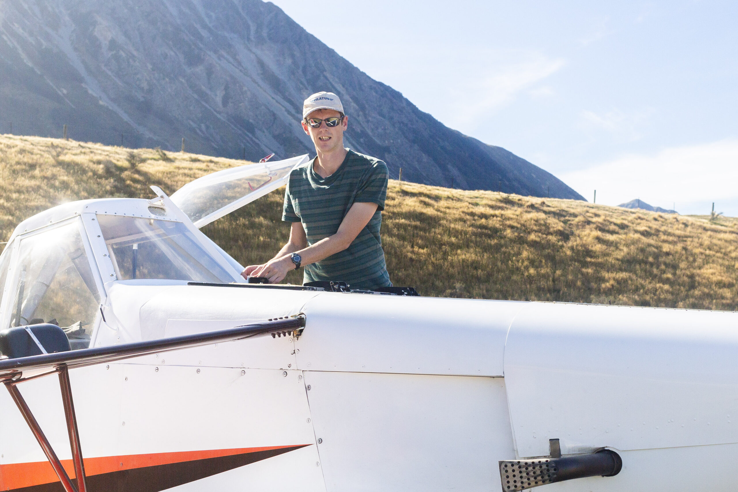 Kahu Soaring instructor with a glider and mountain backdrop